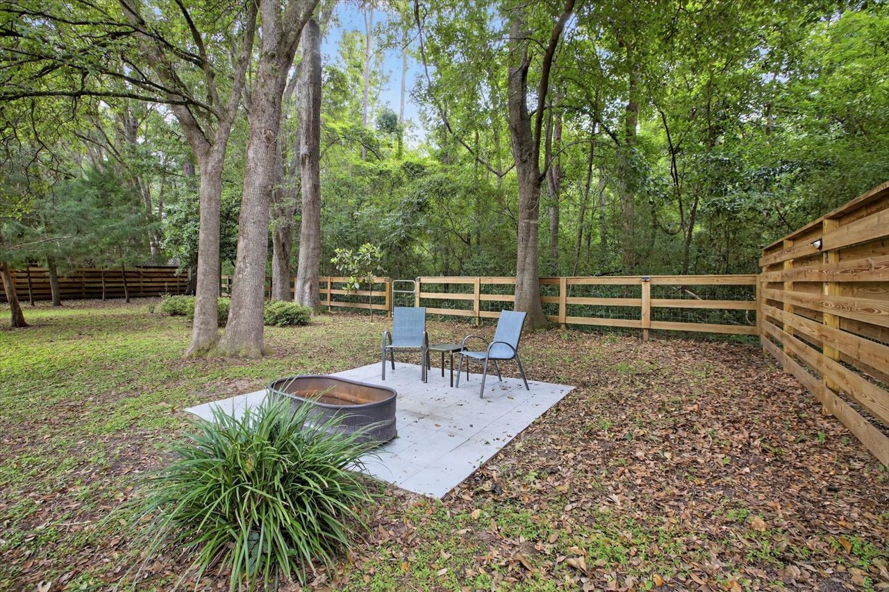 Firepit and fenced backyard at Clifden